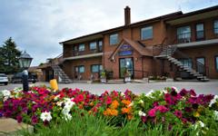 Newmarket Inn | East Gwillimbury, Ontario, L9N 0J2 | Exterior of Newmarket Inn during the day with multicolored flowers