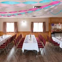Newmarket Inn | East Gwillimbury, Ontario, L9N 0J2 | Meeting room tables with red chairs and blue and pink streamers hanging